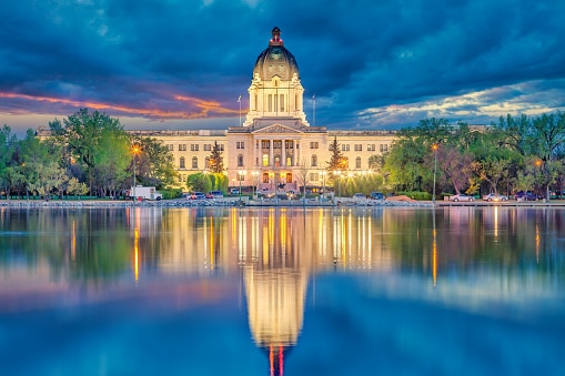 The Saskatchewan Legislature reflects onto Wascana Lake.