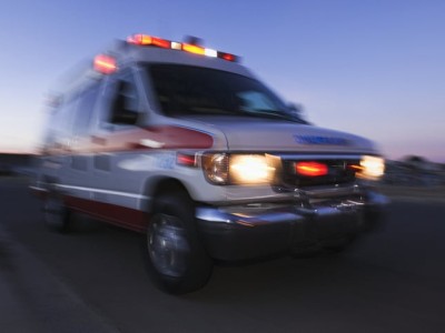 Blurred view of ambulance driving at dusk